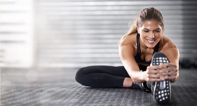 Fitness, woman and stretching legs on mockup in preparation for workout, exercise or training on gym floor. Happy sporty female in warm up leg stretch getting ready for healthy exercising or wellness.