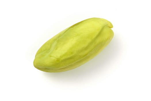 Single peeled green pistachio nut isolated on white background.