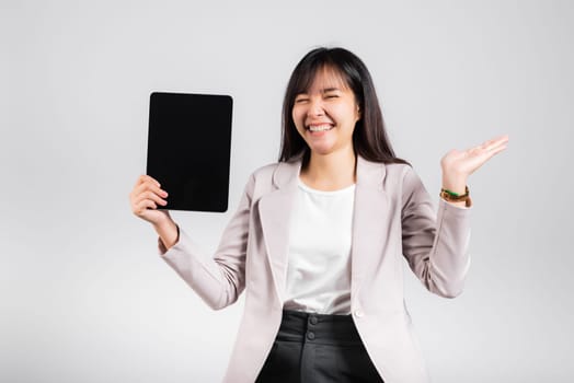 Asian beautiful young woman smiling using tablet computer, Happy female show blank screen digital tablet pc and presenting product with palm of hand at empty, studio shot isolated on white background
