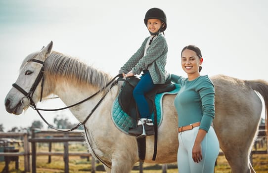 .Portrait of woman standing, child on horse and ranch lifestyle with smile and equestrian sports on field. Countryside, rural nature and farm animals, mother teaching girl to ride stallion in USA
