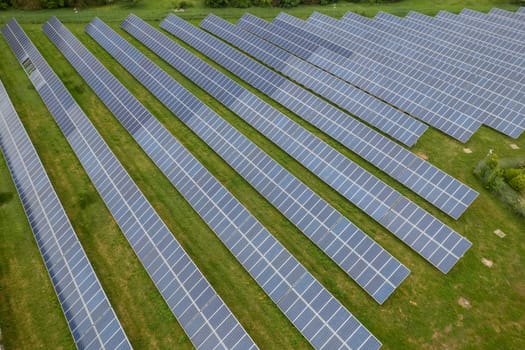 Renewable energy. Aerial shot drones fly over a photovoltaic power station. Group pf solar panels looking the sun for energy production.