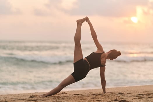 Beautiful girl doing yoga at the beach. High quality photo