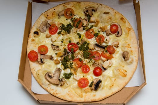 Whole Italian pizza pepperoni and cheese pizza in cardboard delivery box. Close-up. Selective focus.