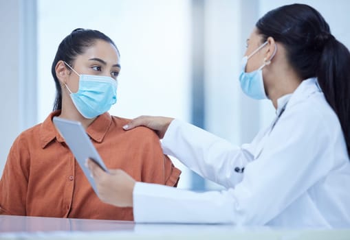 Covid, face mask and doctor on tablet consulting patient for corona virus vaccine or treatment. Health, safety and medical woman talking, help or support for covid 19 checkup in hospital on tech