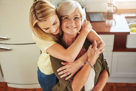Hug, woman or portrait of happy mother in kitchen bonding together with love at home in Italy. Above, embrace or adult daughter hugging or helping senior mom in family house cooking lunch or dinner.
