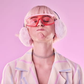 Fashion, woman and quirky on a pink background in studio with funny glasses for cyberpunk style. Face of edgy, trendy or retro aesthetic person with vaporwave, creativity and art color clothes.