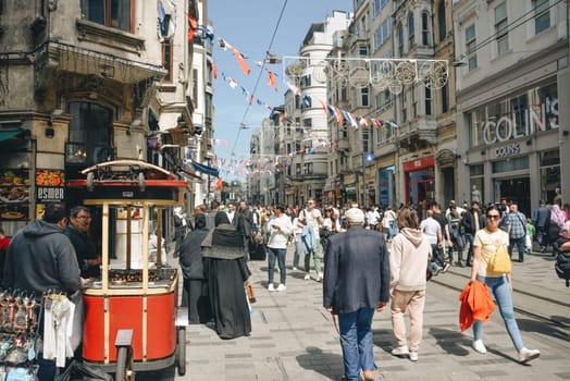 Istanbul, Turkey - May 02, 2023: Nostalgic traditional red tram in Beyoglu. The tram line runs along Istiklal Street (a popular place in Istanbul) between Taksim Square and the metro.