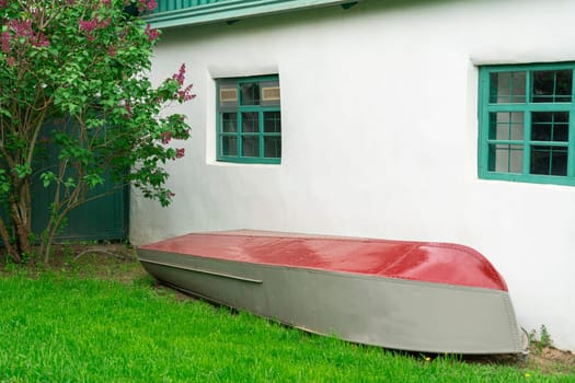 an overturned fishing boat in storage at the building