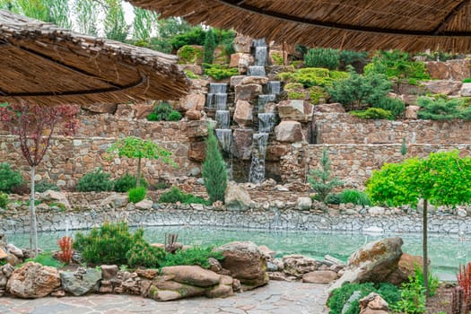 courtyard with waterfall and swimming pool in the hotel. photo