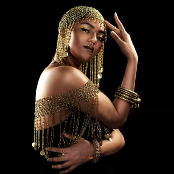 African woman, portrait and gold fashion with beauty and cosmetics in a studio. Isolated, black background and young female face with crown, Egypt jewelry and culture empowerment with queen pride.