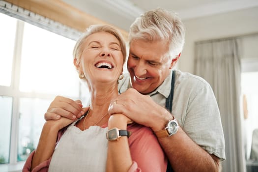 Love embrace, communication and senior couple holding hands and laughing at funny conversation in the living room of their house. Happy elderly man and woman with smile in retirement together.