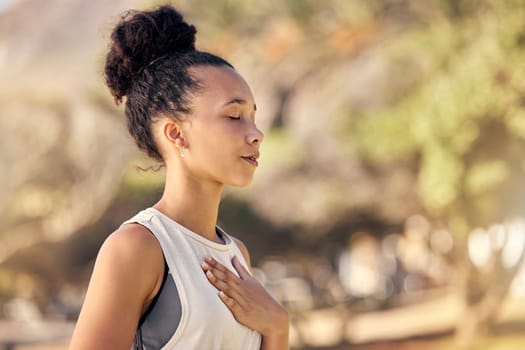 Black woman, breath and hand on chest, for meditation and wellness being peaceful to relax. Bokeh, African American female and lady outdoor, in nature and being calm for breathing exercise and health.