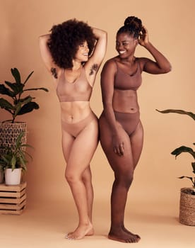 Diversity, body and natural with black woman friends in studio on a beige background for beauty or equality. Health, wellness and armpit hair with a model female and friend posing in underwear.