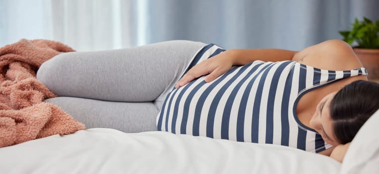 Pregnant, rest and woman on bed, health and wellness to relax, break and touching stomach. Pregnancy, female and lady in bedroom, maternity leave and peace in home, growth and support for development.