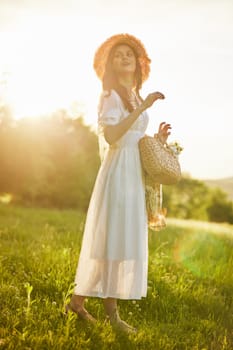 a woman in a light dress walks in the countryside in the rays of the setting sun. High quality photo