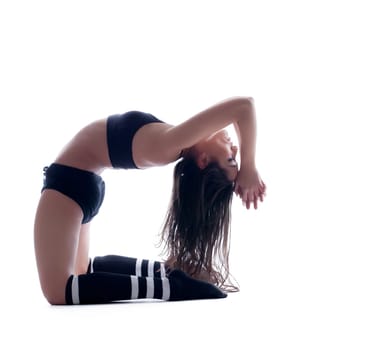 Harmonous flexible brunette posing in studio, isolated on white