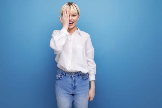 young caucasian woman with a short haircut is dressed in a white shirt on background with copy space. people lifestyle concept.