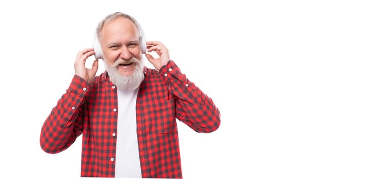 middle age business. handsome mature gray-haired man with a beard and headphones.