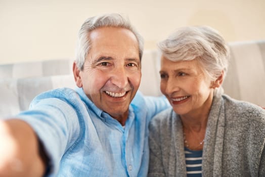 Senior couple, happy selfie and couch in retirement home for social media, blog post and internet. Elderly man, woman and photography for profile picture on app, web or smile together on lounge sofa.