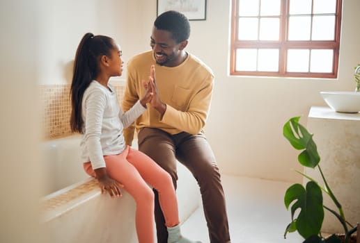 Black family, high five and happy child with father in home bathroom with love, care and support. Man and girl kid for a pep talk and communication with a smile, energy and celebration of trust.