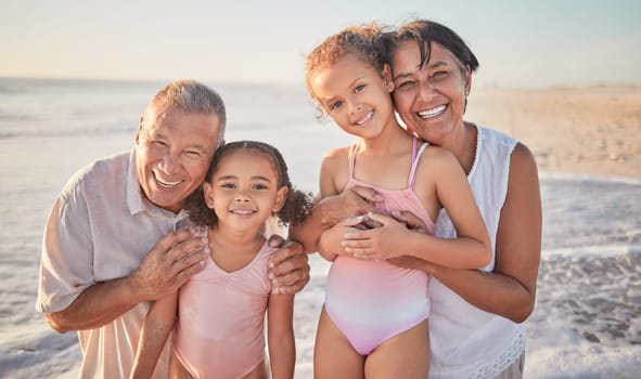 Family, children and beach with a girl, grandparents and sister on the sand by the ocean or sea at sunset. Kids, summer and travel with a grandfather, grandmother and grandchildren on holiday.