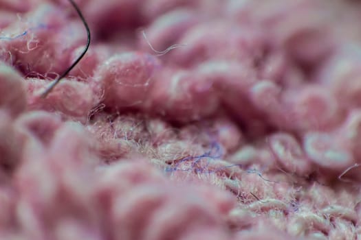 Macro closeup of soft pink fabric background.