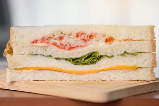 Delicious sandwich bread on a wooden table with blurred background for bakery, food and eating concept