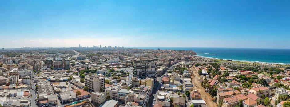 Panorama aerial view of south Tel Aviv neighborhoods and Old Jaffa. A combination of new and old construction. Recognized places such as the Etzel Museum, Old Jaffa Port, Tel Aviv promenade and Neve Tzedek neighborhood.