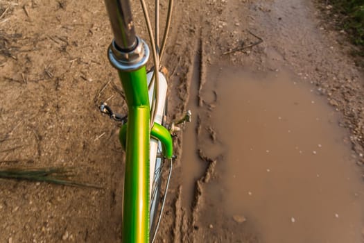 Bicycle ride through muddy dirt road.