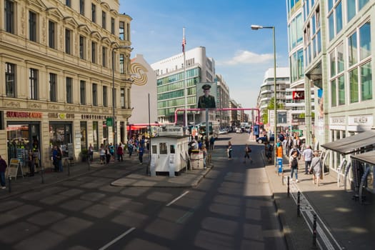 Berlin, Germany - May 17, 2017: Tourists at Checkpoint Charlie. former Berlin Wall border crossing point between East and West Berlin during the Cold War.