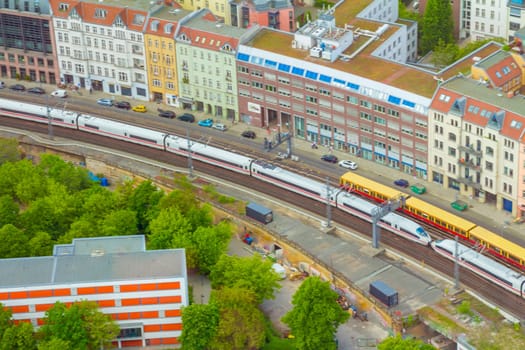 Aerial view of Berlin skyline with S-Bahn tracks rapid train and colorful buildings.