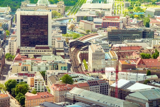 Aerial view of Berlin skyline with S-Bahn tracks rapid train and colorful buildings.