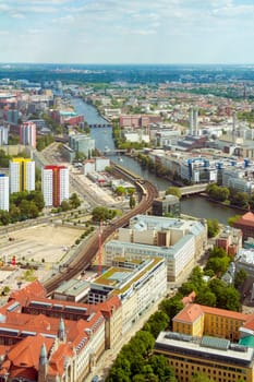 Aerial view of Berlin skyline with S-Bahn tracks rapid train and colorful buildings.