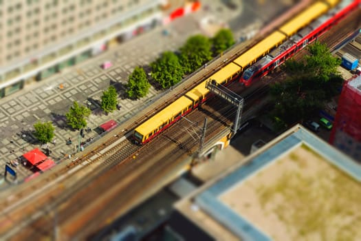 Aerial view of the S-Bahn tracks rapid train and tram train at the Alexanderplatz public square in Berlin. with tilt-shift effect.