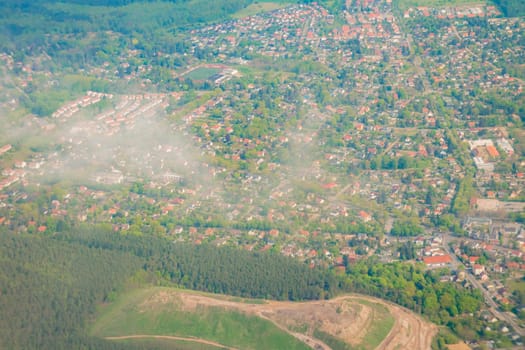 Aerial view over the small town and green area in Germany.