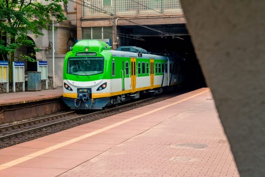 Electric passenger train arrives at the railway station in Warsaw Poland.