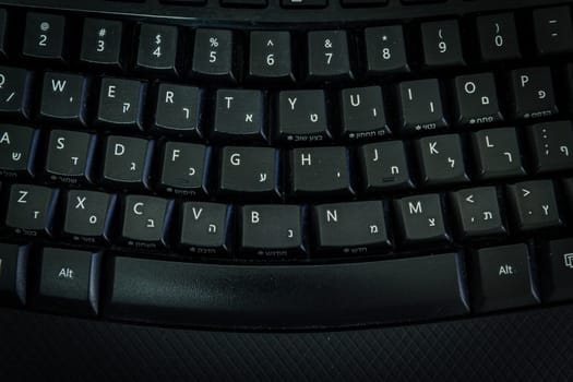 Keyboard with letters in Hebrew and English - Wireless keyboard - Top View -  Dark atmosphere