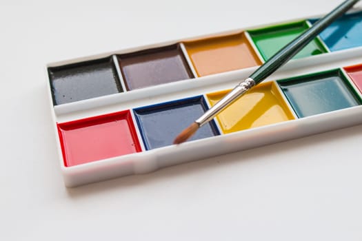 The complete set of water colour paints on a white background