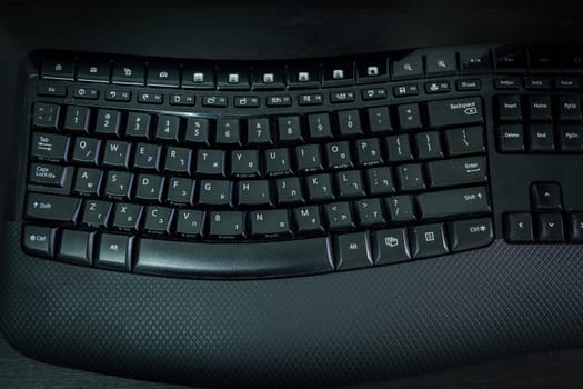 Keyboard with letters in Hebrew and English - Wireless keyboard - Top View -  Dark atmosphere