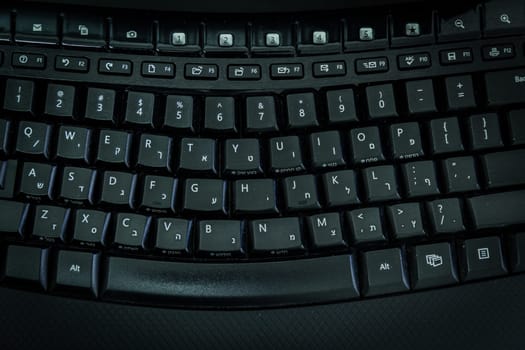 Keyboard with letters in Hebrew and English - Wireless keyboard - Top View -  Dark atmosphere