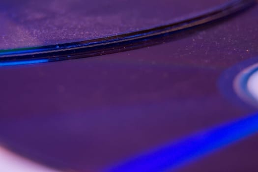 Macro closeup of Compact CD or DVD disc in violet color.