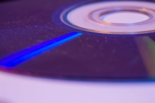 Macro closeup of Compact CD or DVD disc in violet color.