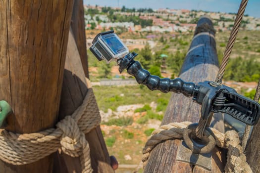 Action camera on stick on climbing tower.