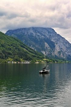 Beautiful misty and cloudy landscape with lake and mountains in summer. Natural colorful background. Traunsee lake in the Austrian applause - Gmunden.