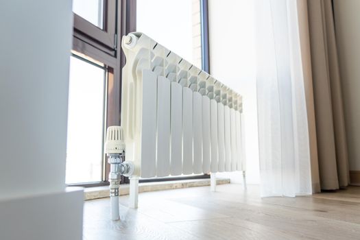 White big radiator near window in a modern room