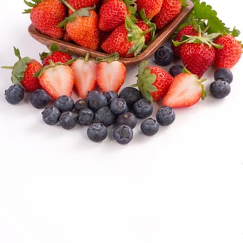 A bowl set of beautiful and delicious strawberry and blueberry isolated on white background, close up, copy space, clipping path, cut out.