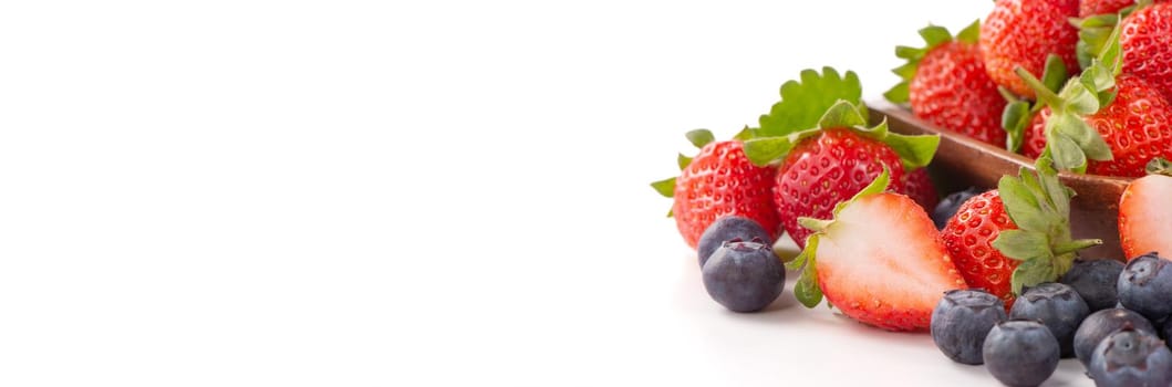 A bowl set of beautiful and delicious strawberry and blueberry isolated on white background, close up, copy space, clipping path, cut out.