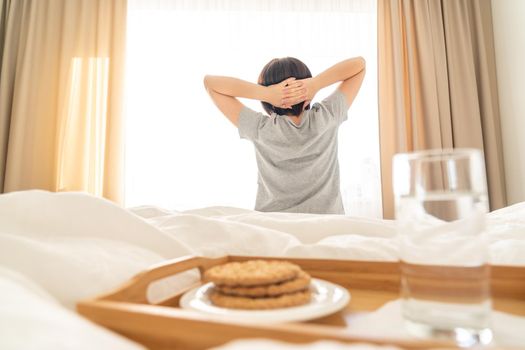 Tray with breakfast on a bed in a hotel room