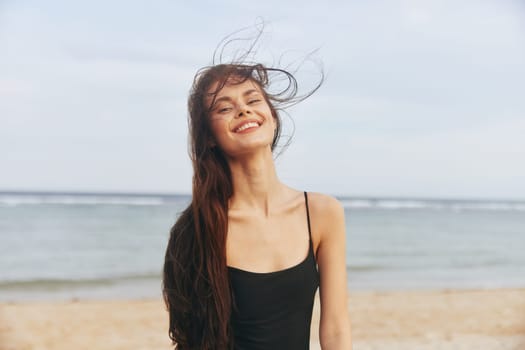 woman beach sea copy-space relax beautiful caucasian vacation water ocean lifestyle sand sky shore smile summer peaceful sunset leisure enjoyment female