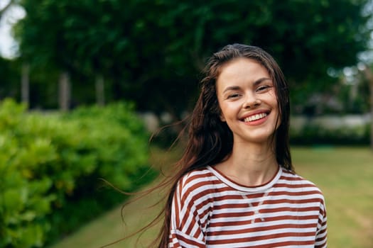 woman portrait smiling walk black nature park bag long freedom beautiful natural lifestyle outdoor active hair joy t-shirt summer sunset relax smile